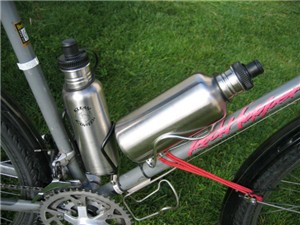 TwoStainless Steel Klean Kanteens Water Bottles mounted on a touring Bicycle